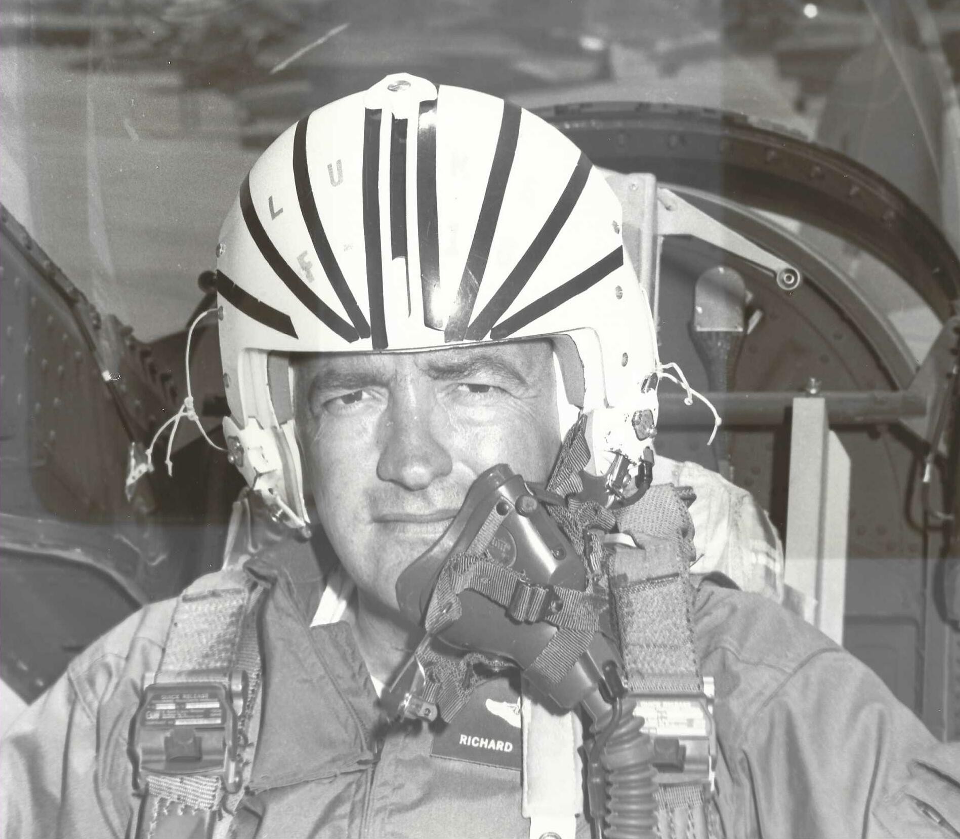 Colonel Richard Ryer in the cockpit wearing a striped flight helmet